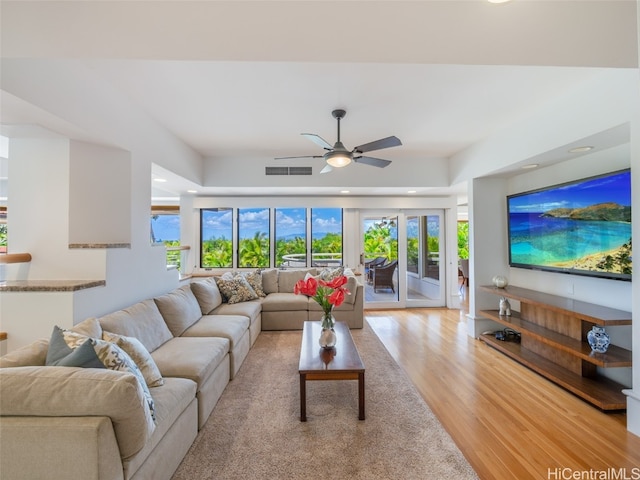 living room featuring light wood-type flooring and ceiling fan