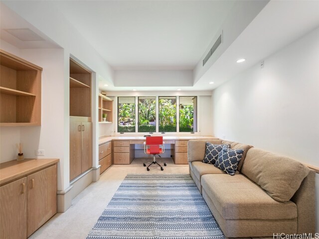 office area with built in desk and light colored carpet