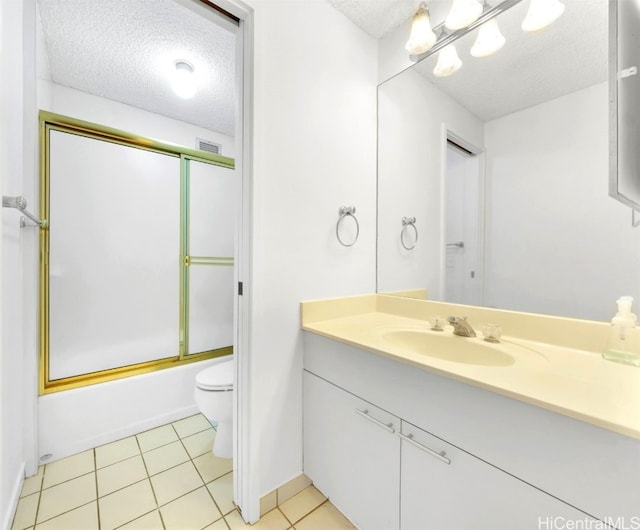 bathroom with visible vents, toilet, combined bath / shower with glass door, a textured ceiling, and vanity