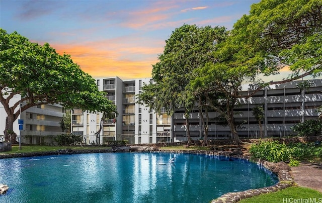 view of pool at dusk