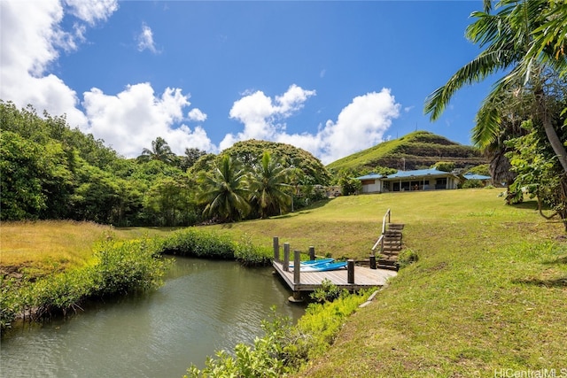 view of dock featuring a yard and a water view