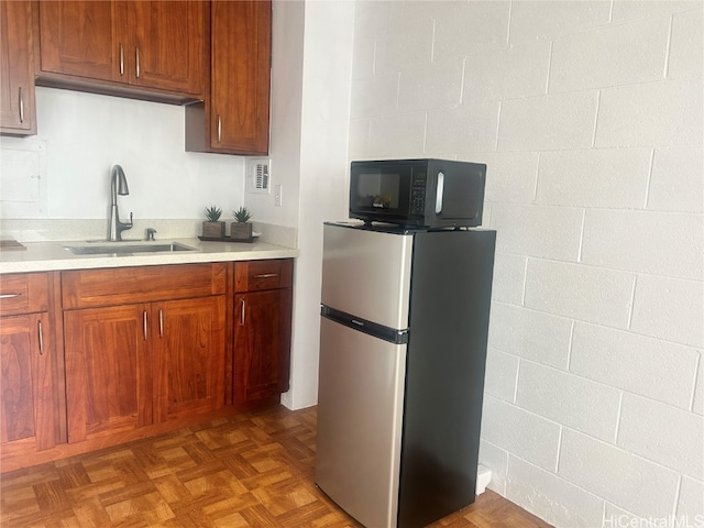 kitchen with sink, stainless steel fridge, and parquet floors