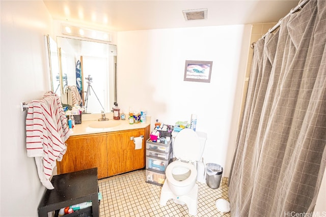 bathroom with toilet, vanity, and a shower with shower curtain