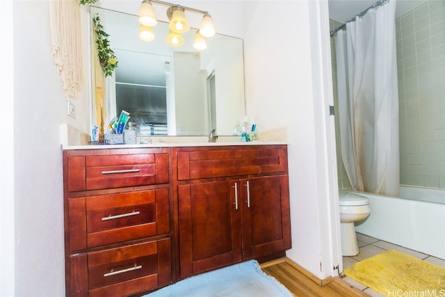 full bathroom featuring vanity, toilet, shower / bathtub combination with curtain, and wood-type flooring