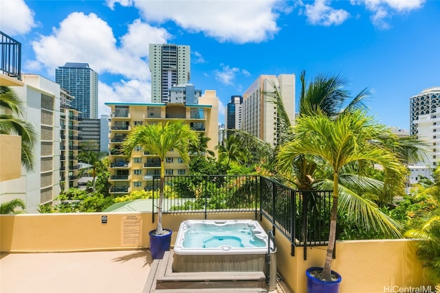 view of swimming pool with an outdoor hot tub