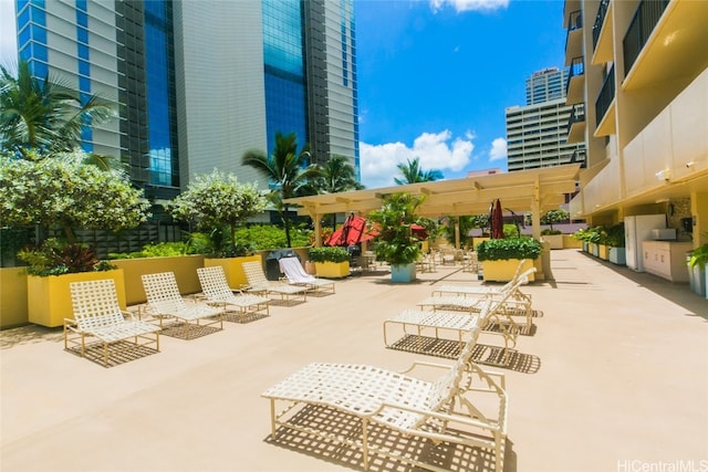 view of community with a patio and a pergola