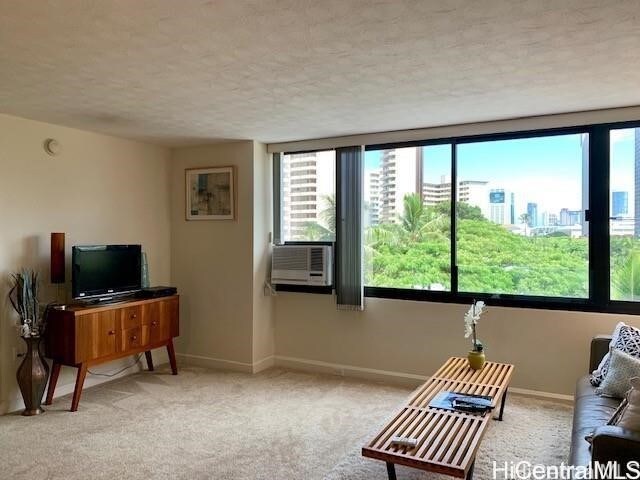 carpeted living room with a textured ceiling