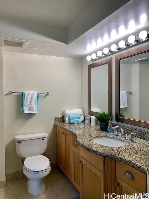 bathroom featuring vanity, toilet, and tile patterned floors