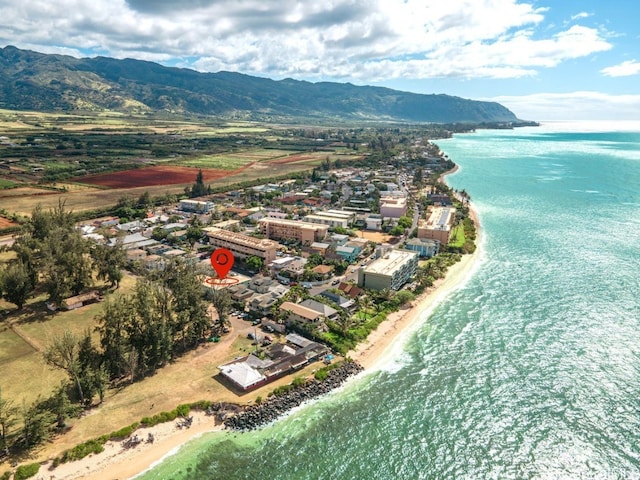 aerial view featuring a water and mountain view and a view of the beach