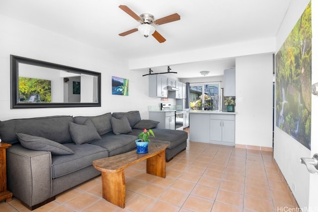 living room featuring ceiling fan and light tile patterned floors