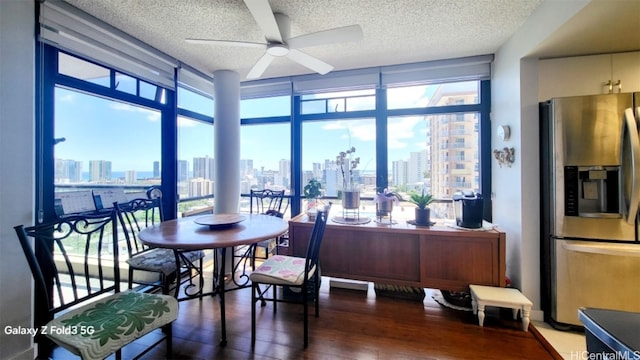 dining space with dark wood-type flooring, ceiling fan, and plenty of natural light