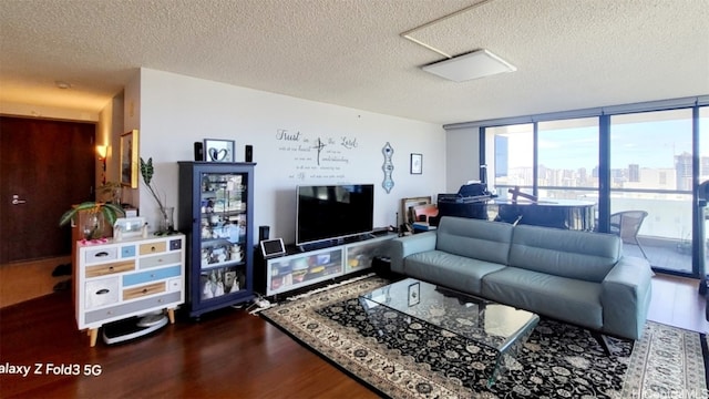 living room featuring a textured ceiling, wood-type flooring, and floor to ceiling windows