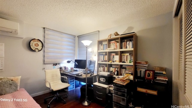 office area with a textured ceiling, an AC wall unit, and dark wood-type flooring