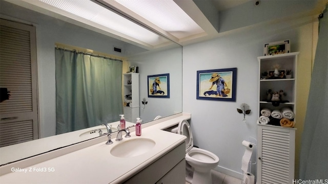 bathroom with toilet and vanity