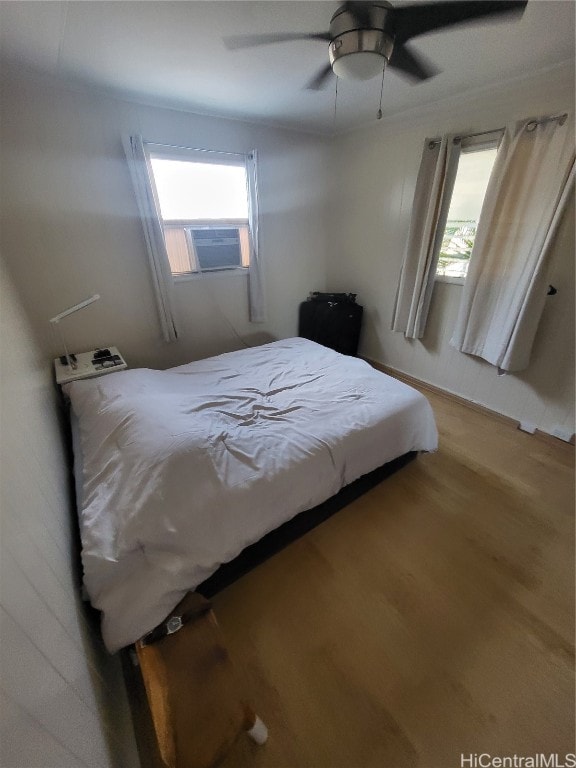 bedroom featuring ceiling fan and hardwood / wood-style flooring