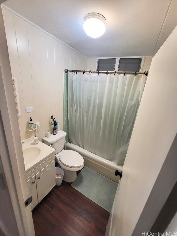 full bathroom featuring vanity, wood-type flooring, toilet, and shower / bathtub combination with curtain