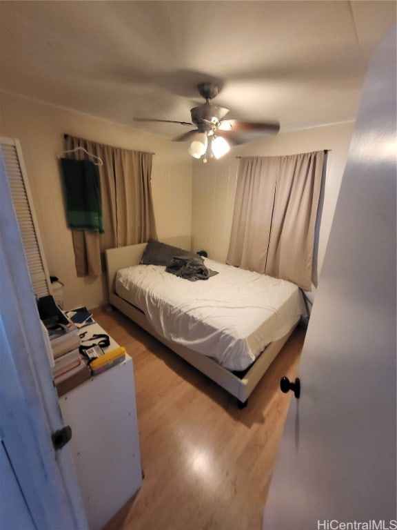 bedroom with hardwood / wood-style floors and ceiling fan