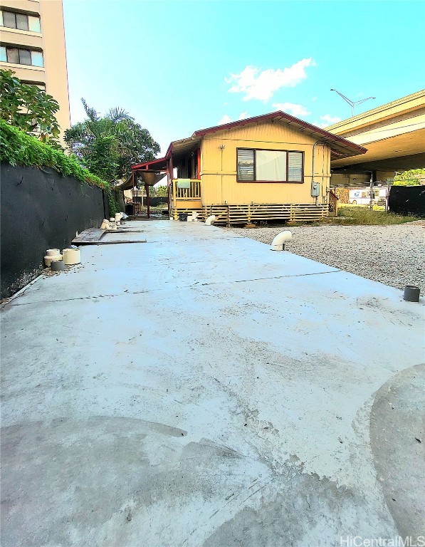 view of side of property with a carport