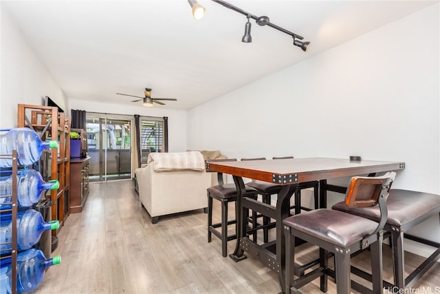 dining space with light wood-type flooring and ceiling fan