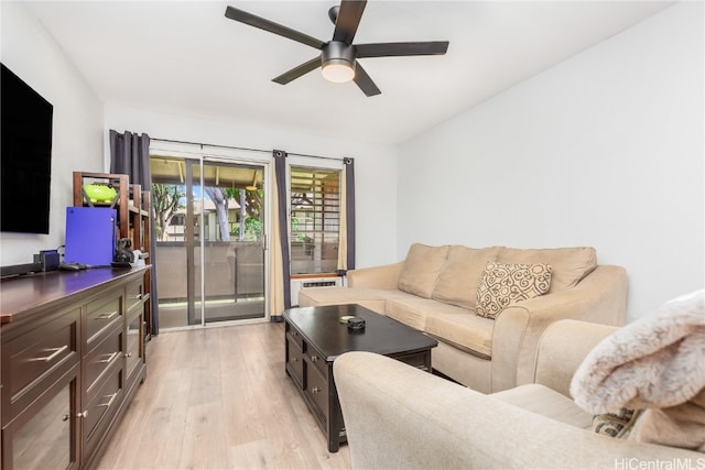 living room with light hardwood / wood-style floors and ceiling fan