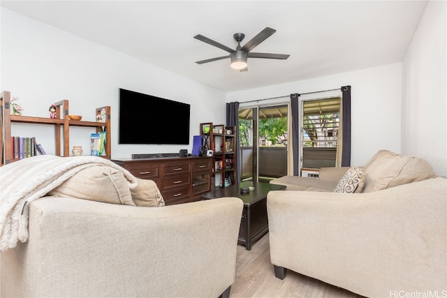 living room featuring light wood-type flooring and ceiling fan