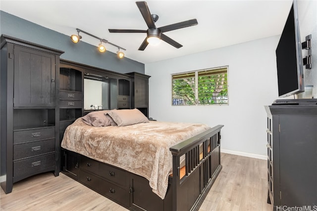 bedroom with light hardwood / wood-style flooring and ceiling fan