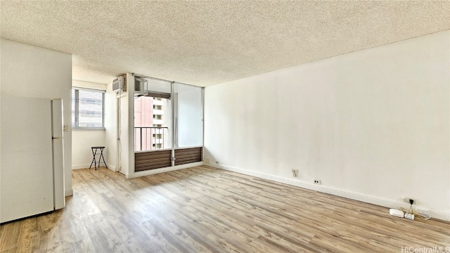 unfurnished bedroom with a textured ceiling and light hardwood / wood-style floors