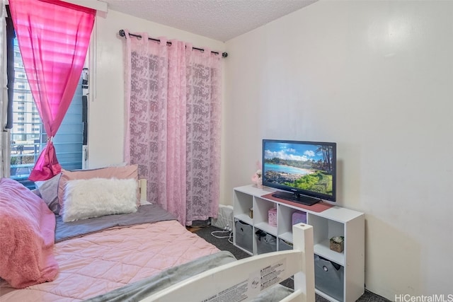 carpeted bedroom featuring a textured ceiling