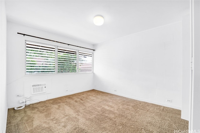 carpeted spare room with a wall mounted air conditioner