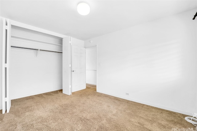 unfurnished bedroom with a closet and carpet floors