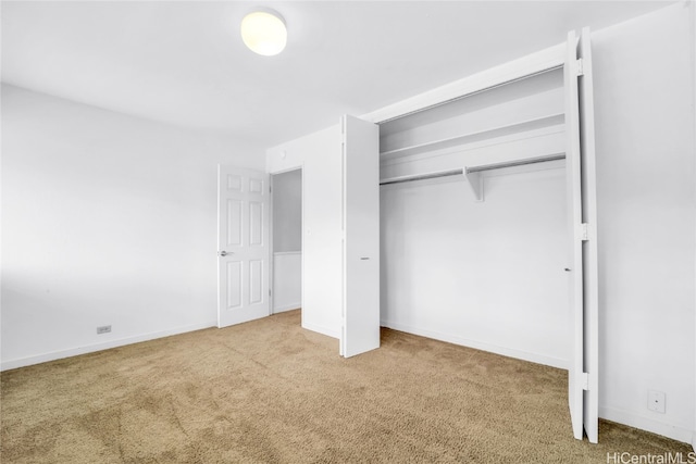 unfurnished bedroom with a closet and carpet