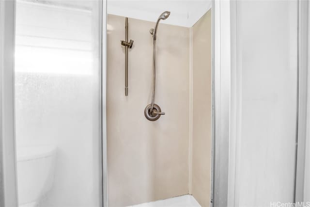 bathroom featuring toilet and a shower