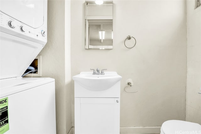 laundry room with sink and stacked washer and clothes dryer