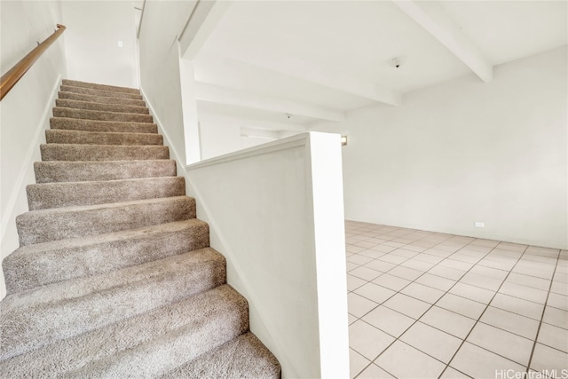 stairs featuring tile patterned floors and beamed ceiling