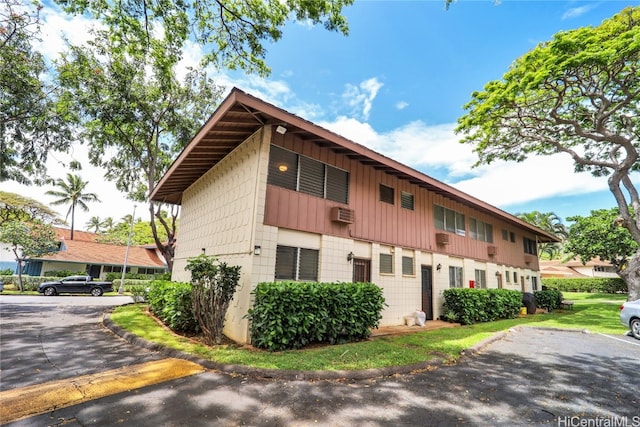 view of side of home featuring a wall mounted AC