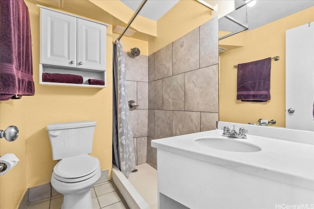 bathroom with a tile shower, tile patterned floors, toilet, and vanity