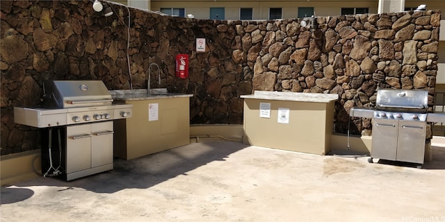 view of patio with sink and a grill