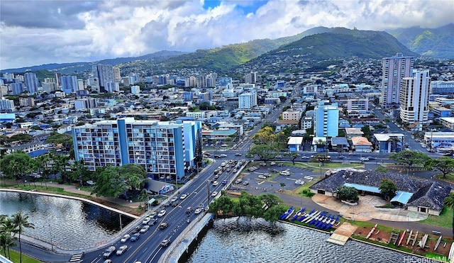 drone / aerial view featuring a water and mountain view