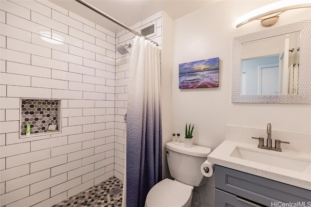 bathroom featuring vanity, toilet, and a stall shower