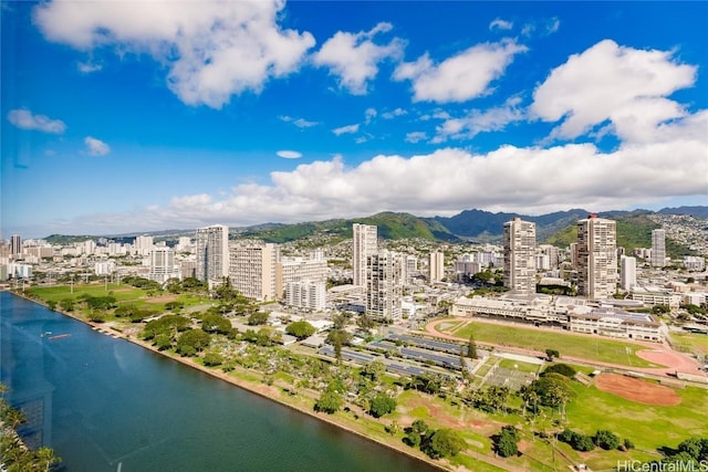 birds eye view of property with a view of city and a water view