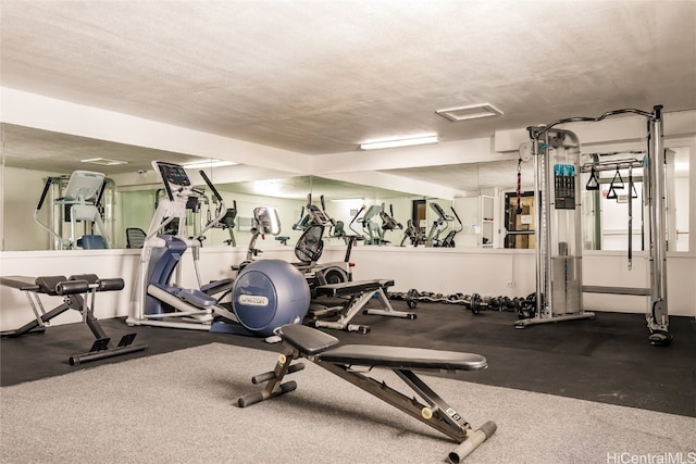 exercise room featuring a textured ceiling