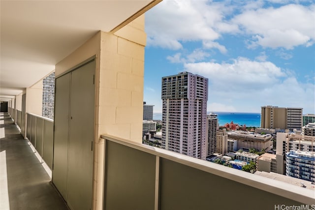 balcony with a view of city and a water view