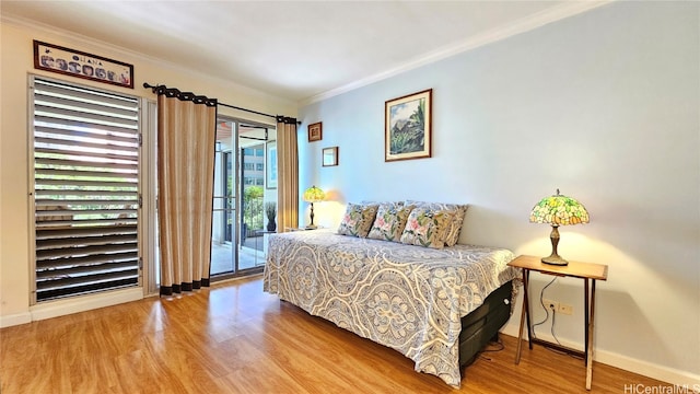 bedroom with crown molding, hardwood / wood-style floors, and access to exterior