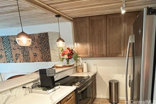 kitchen featuring appliances with stainless steel finishes and decorative light fixtures