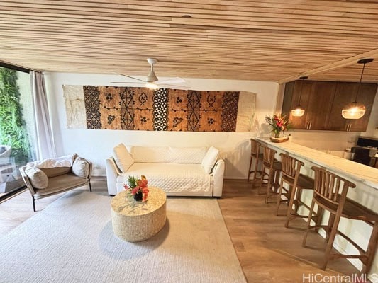 sitting room featuring wood ceiling, wood-type flooring, floor to ceiling windows, and ceiling fan