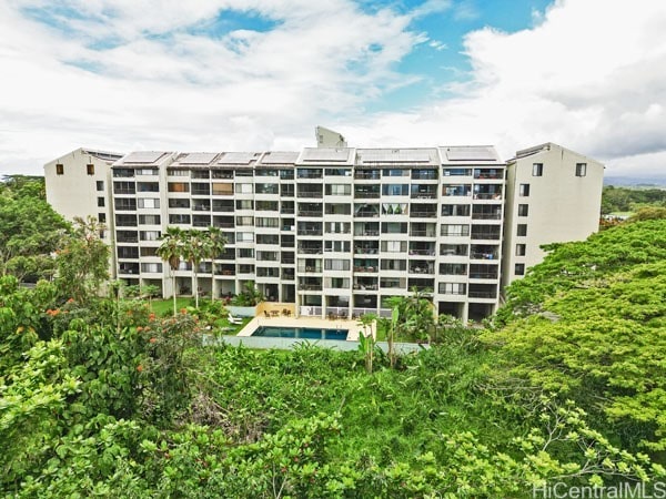 view of building exterior featuring a swimming pool