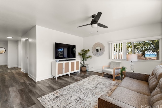 living room featuring ceiling fan and dark hardwood / wood-style flooring