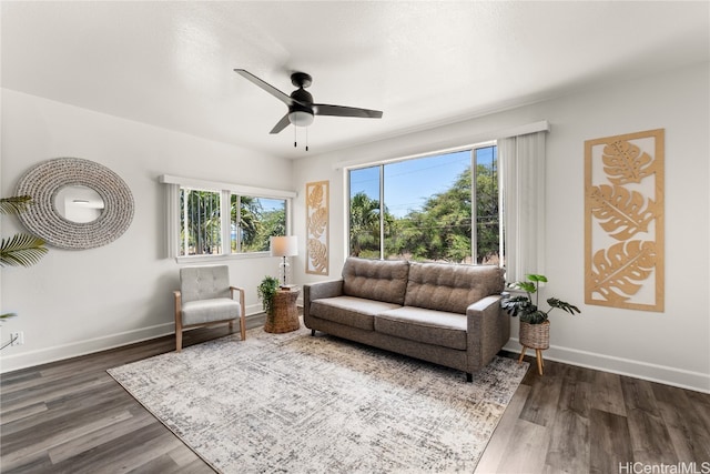 living room with dark hardwood / wood-style floors and ceiling fan