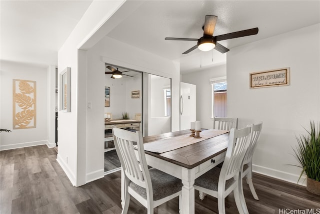 dining space with dark wood-type flooring and ceiling fan