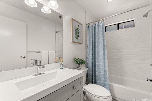 full bathroom featuring vanity, shower / bath combo with shower curtain, and toilet